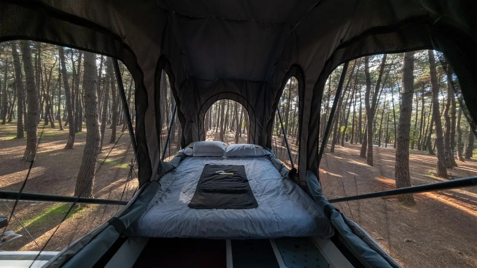 Atlas: the bed in the roof tent, with mesh windows on three sides
