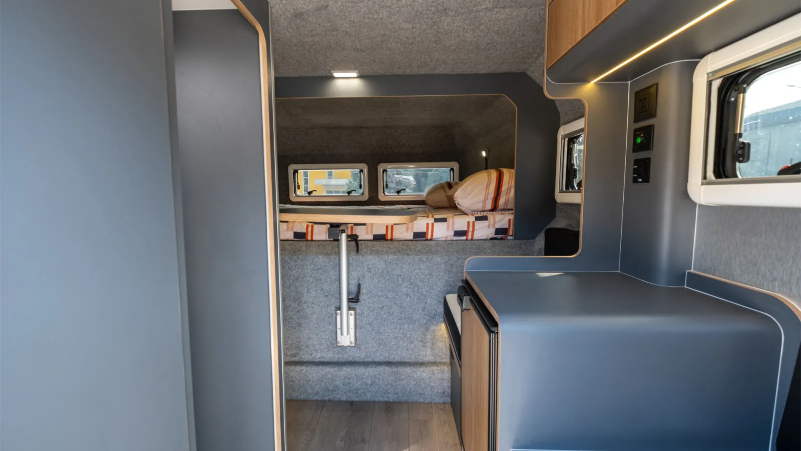 Gladiator L: the cabin from the door: dinette, then the bed over the cab