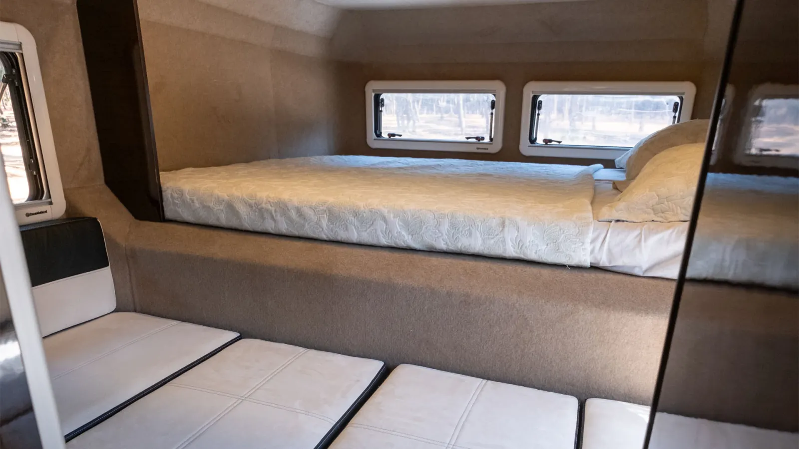 Gladiator SE: the dinette with its cushions laid flat, below the main bed