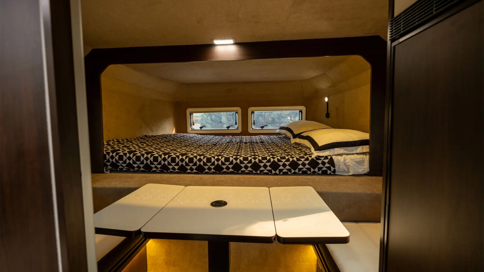 Gladiator XL: dinette under the main bed, tall fridge on the right