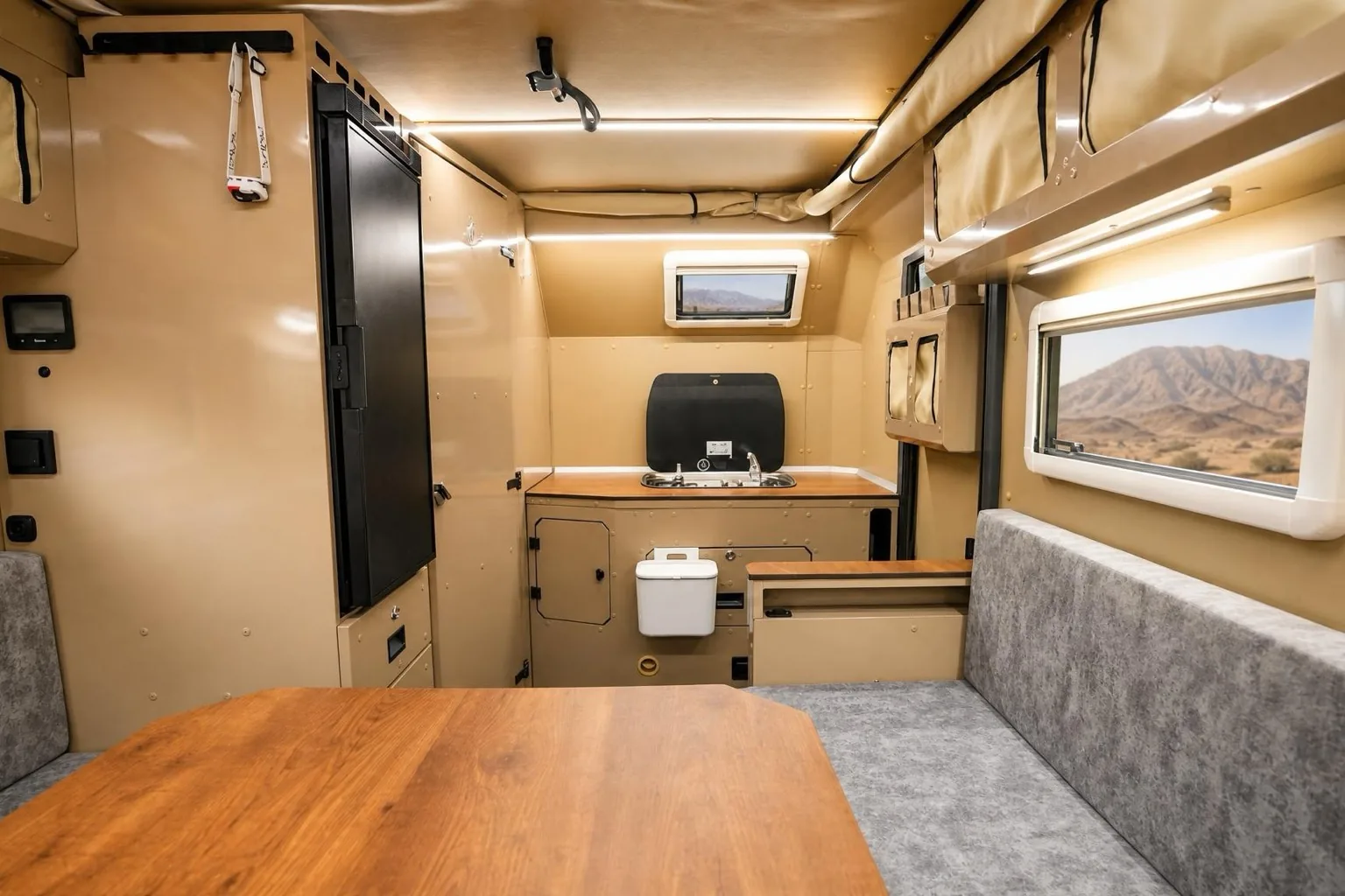 NTR3X: the living space from the door: table, lounge, kitchen and bathroom door